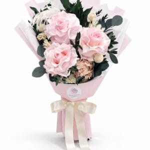 Blush Whisper preserved bouquet with soft pink roses, eucalyptus leaves, delicate filler flowers, and neutral greenery