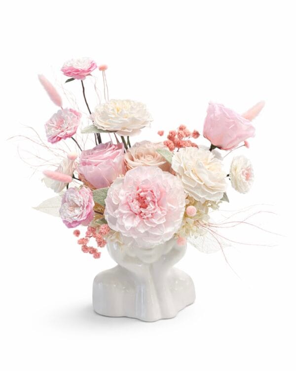 Powdered Dream preserved floral arrangement with blush pink and ivory roses in a sculptural ceramic vase