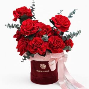 Preserved red rose arrangement with 12 French roses and eucalyptus in a velvet hat box
