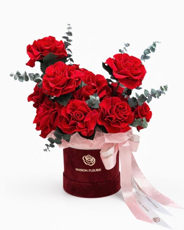 Preserved red rose arrangement with 12 French roses and eucalyptus in a velvet hat box
